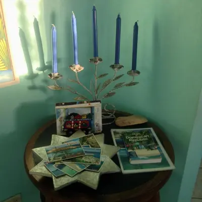 a table with blue candles and books on it at Casa Azul - Apartment in San Felipe de Puerto Plata