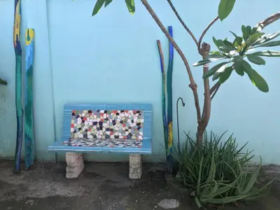 a blue bench sitting in front of a blue wall at Casa Azul - Apartment in San Felipe de Puerto Plata