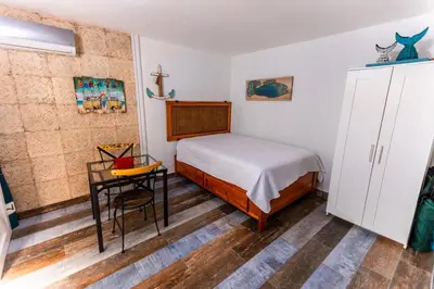 a small bedroom with a bed and a table at Amazing Apartments, A-Juan Dolio, El Bonito II in Juan Dolio