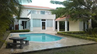 a swimming pool in front of a house at Villas Del Jardin 7 in Juan Dolio