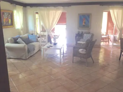 a living room with a couch and a table and chairs at Villas Del Jardin 7 in Juan Dolio