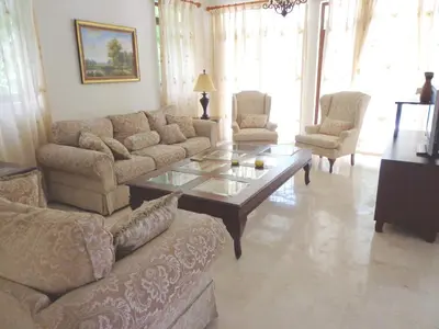 a living room with a couch and a coffee table at Villamorametro in Juan Dolio