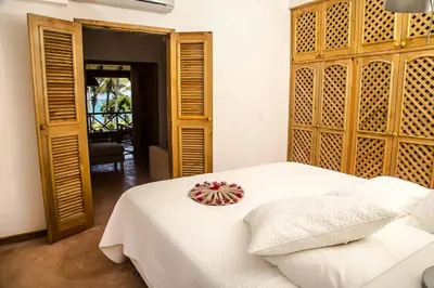a bedroom with a white bed with a bowl on it at Villa Ixora - Ocean Front in Las Galeras