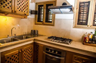 a kitchen with a sink and a stove top oven at Villa Ixora - Ocean Front in Las Galeras