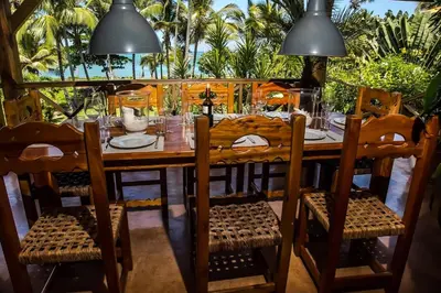 a dining room table with chairs and a table and chairsktop at Villa Ixora - Ocean Front in Las Galeras