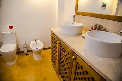 a bathroom with two sinks and a toilet at Jasmine La Playita - Ocean Front in Las Galeras