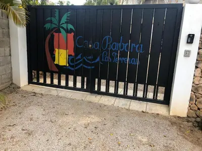 a black gate with a painting of a pineapple on it at Casa Barbara in Las Terrenas