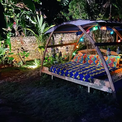 a bed in a gazebo in a garden at night at Casa Barbara in Las Terrenas