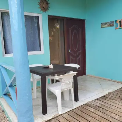 a black table and white chairs on a patio at Casa Barbara in Las Terrenas