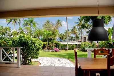 a dining room with a table and a view of a park at Villa Diana in Las Galeras