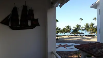 a room with a view of a beach with palm trees at Appartamento Vista Mare in Bayahibe