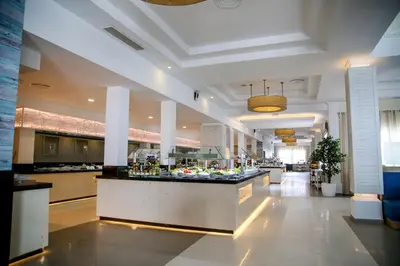 a lobby with a bar in the middle of a building at Bahia Principe Grand Aquamarine - Adults Only All Inclusive in Punta Cana