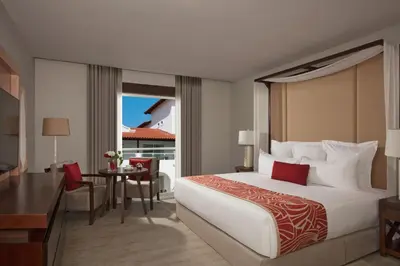 a hotel room with a large bed and a desk at Dreams Dominicus La Romana Resort & Spa in Bayahibe