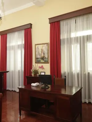 an office with a desk and red curtains at Boutique Hotel Palacio in Santo Domingo