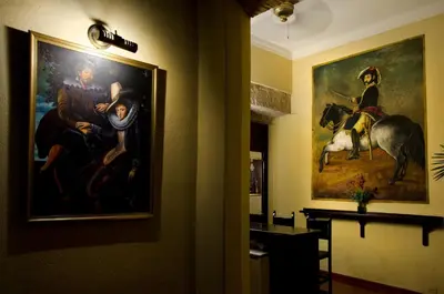 a painting hanging on a wall in a room at Boutique Hotel Palacio in Santo Domingo