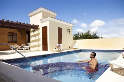 a man is sitting in a swimming pool at Boutique Hotel Palacio in Santo Domingo
