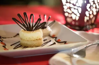 a piece of cake on a white plate with forks at BlueBay Villas Doradas Adults Only-All Inclusive in San Felipe de Puerto Plata