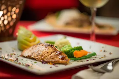 a plate of food with meat and vegetables on a table at BlueBay Villas Doradas Adults Only-All Inclusive in San Felipe de Puerto Plata