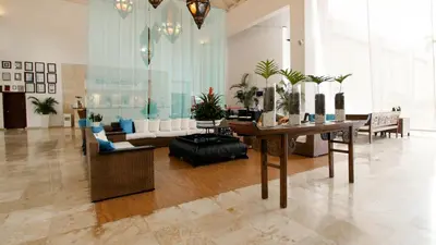a living room with a table and a couch at BlueBay Villas Doradas Adults Only-All Inclusive in San Felipe de Puerto Plata