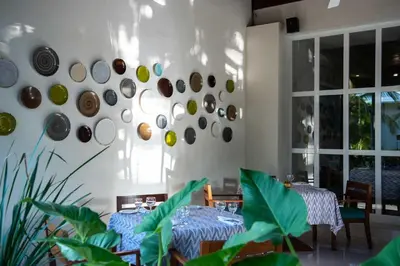 a dining room with two tables and plates on the wall at Grand Sirenis Punta Cana Resort & Aquagames - All Inclusive in Punta Cana