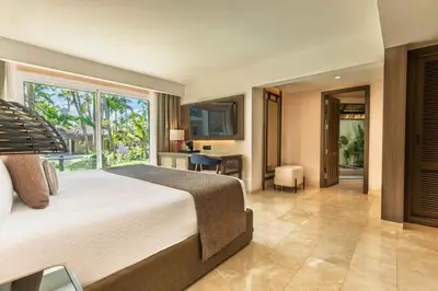 a bedroom with a large bed and a balcony at Grand Palladium Select Bávaro - All Inclusive in Punta Cana