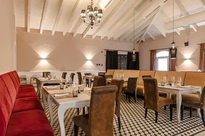 a restaurant with tables and chairs and a couch at Grand Palladium Punta Cana Resort & Spa - All Inclusive in Punta Cana