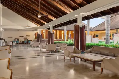a lobby with couches and tables and chairs at Grand Palladium Palace Resort Spa & Casino - All Inclusive in Punta Cana