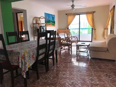 a living room with a table and chairs and a couch at Plaza Real Resort in Juan Dolio