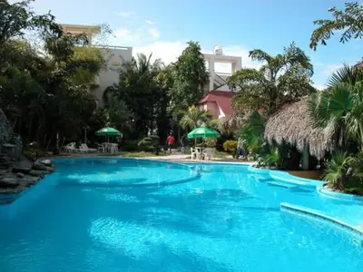 a large blue swimming pool in a resort at Plaza Real Resort in Juan Dolio