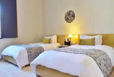 a hotel room with two beds in a room at Hodelpa Nicolás de Ovando in Santo Domingo