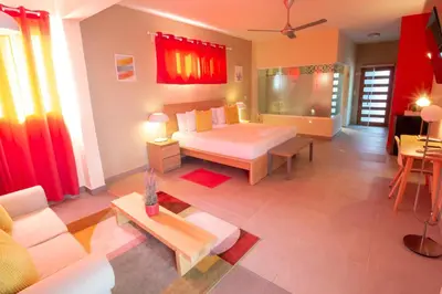 a living room with a couch and a table at Casa Valeria Boutique Hotel in Sosúa