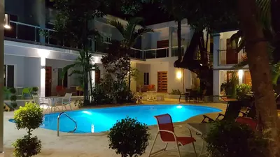 a pool in front of a house at night at Casa Valeria Boutique Hotel in Sosúa