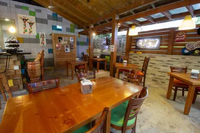 a dining room with wooden tables and chairs at Casa Valeria Boutique Hotel in Sosúa