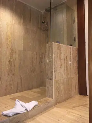 a bathroom with a shower with a glass wall at VIK hotel Arena Blanca in Punta Cana