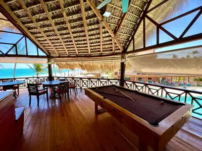 a pool table in a room with tables and chairs at VIK Hotel Cayena Beach All Inclusive in Punta Cana