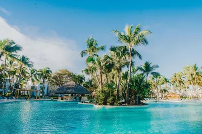 a pool with palm trees and a resort at Grand Bavaro Princess - All Inclusive in Punta Cana