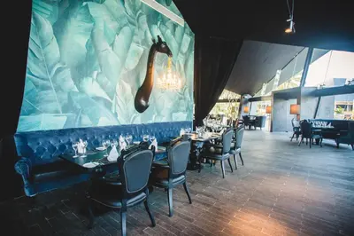 a restaurant with tables and chairs and a giraffe mural at Grand Bavaro Princess - All Inclusive in Punta Cana