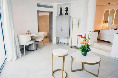 a living room with a bed and a table and chairs at Grand Bavaro Princess - All Inclusive in Punta Cana