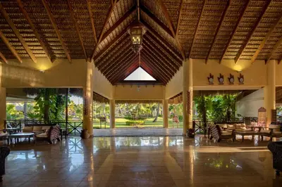 a lobby of a resort with tables and chairs at Punta Cana Princess Adults Only - All Inclusive in Punta Cana