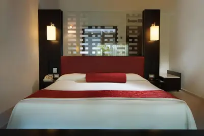 a bedroom with a large white bed with a red blanket at Punta Cana Princess Adults Only - All Inclusive in Punta Cana