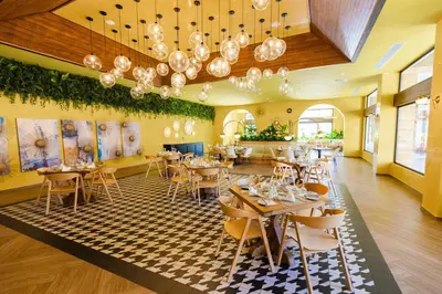a restaurant with tables and chairs in a room at Caribe Deluxe Princess - All Inclusive in Punta Cana