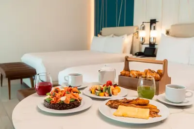 a table with three plates of food on it at Hard Rock Hotel & Casino Punta Cana - All Inclusive in Punta Cana
