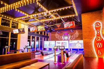 a bowling alley with bowling lanes and neon signs at Hard Rock Hotel & Casino Punta Cana - All Inclusive in Punta Cana