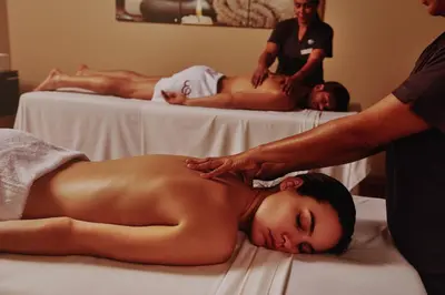 a shirtless woman getting a massage at a spa at El Embajador, a Royal Hideaway Hotel in Santo Domingo