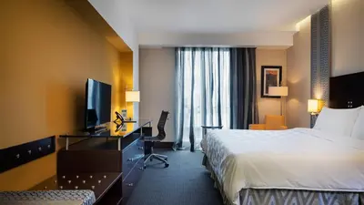 a hotel room with a bed and a television at Holiday Inn Santo Domingo by IHG in Santo Domingo