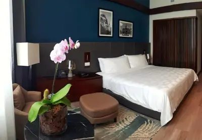 a hotel room with a bed and a chair at Holiday Inn Santo Domingo by IHG in Santo Domingo