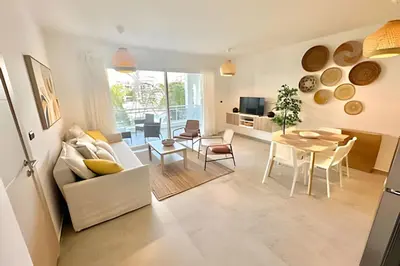a living room with a white couch and a table at Estrella Dominicus Advantage in Bayahibe
