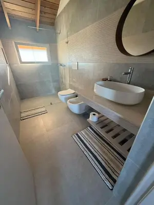 a bathroom with two toilets and a sink at Estrella Dominicus Advantage in Bayahibe