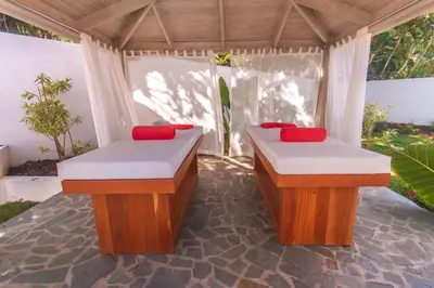 two nesting tables in a porch with red pillows at CASA-22 Luxury Boutique Hotel in Sosúa