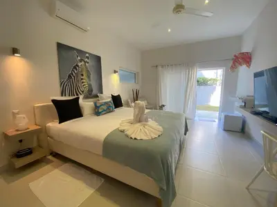 a bedroom with a bed with a zebra picture on the wall at CASA-22 Luxury Boutique Hotel in Sosúa